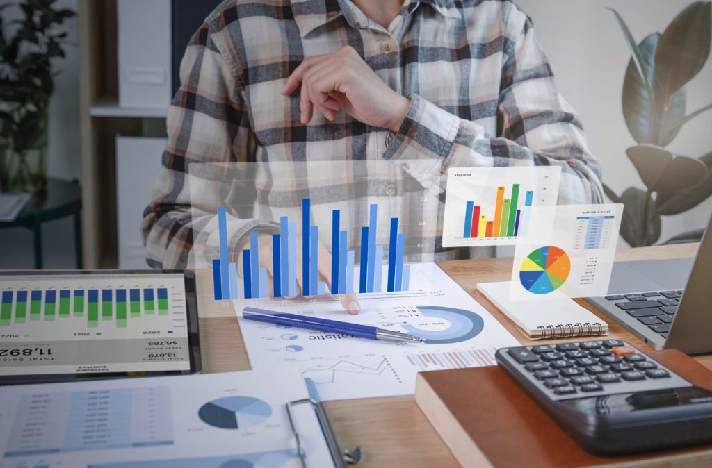 Accounting charts, calculator, and financial reports on a desk