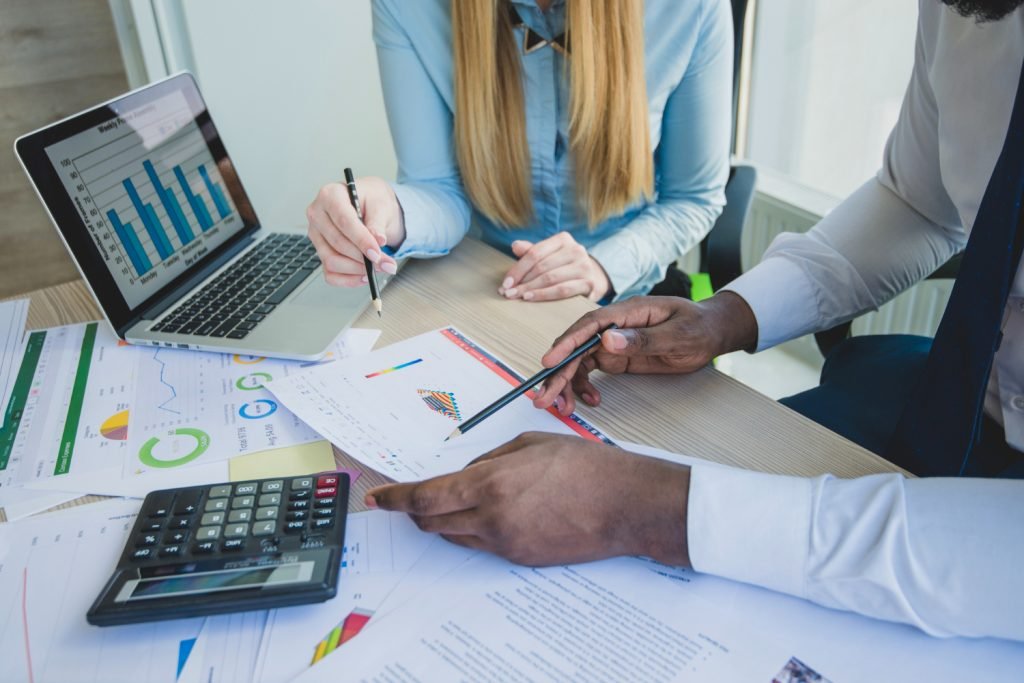 Business tax planning meeting with financial charts and calculator